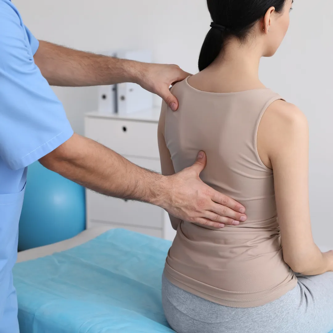 doctor checking woman spine
