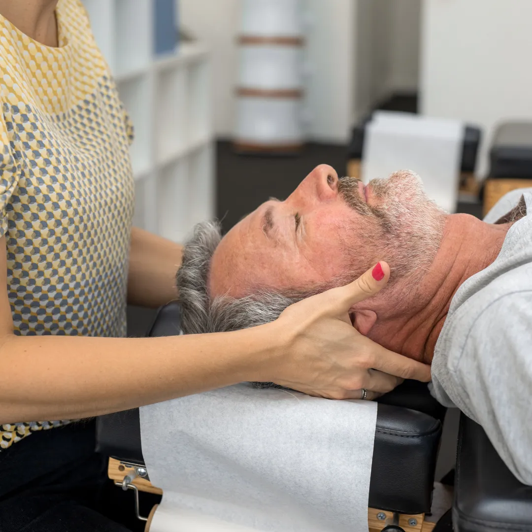 doctor fixing a man neck